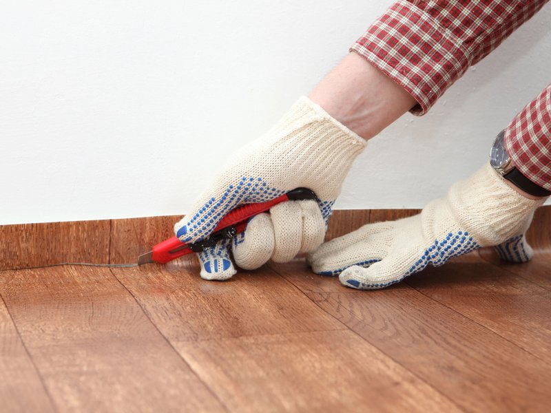 person installing a vinyl sheet